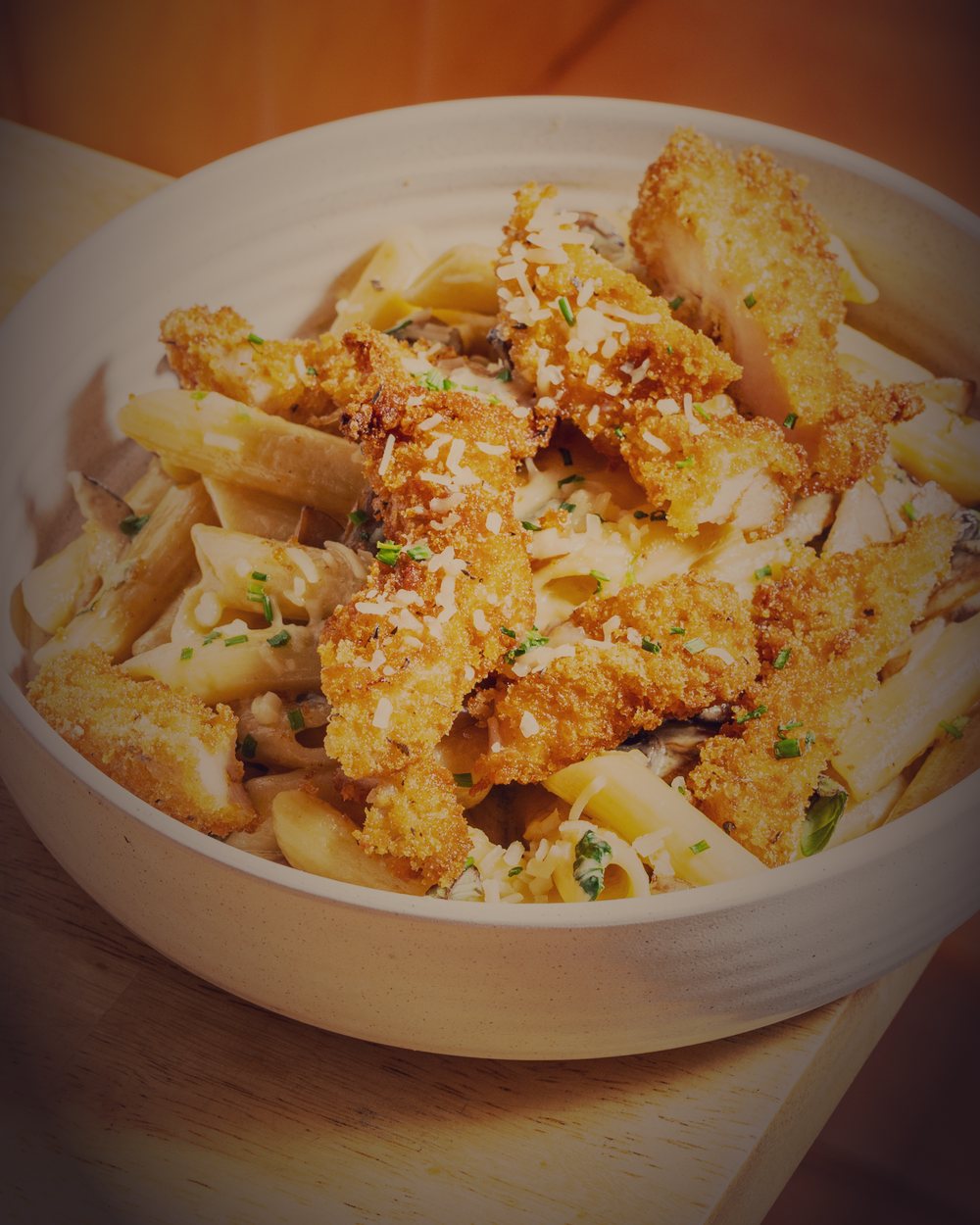 Creamy chicken pasta at Averra in low evening light