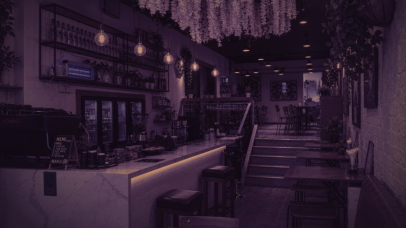The Averra dining room at night, lit by warm pendant bulbs